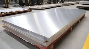 Polished stainless steel sheets stacked in warehouse, ideal for industrial and construction applications